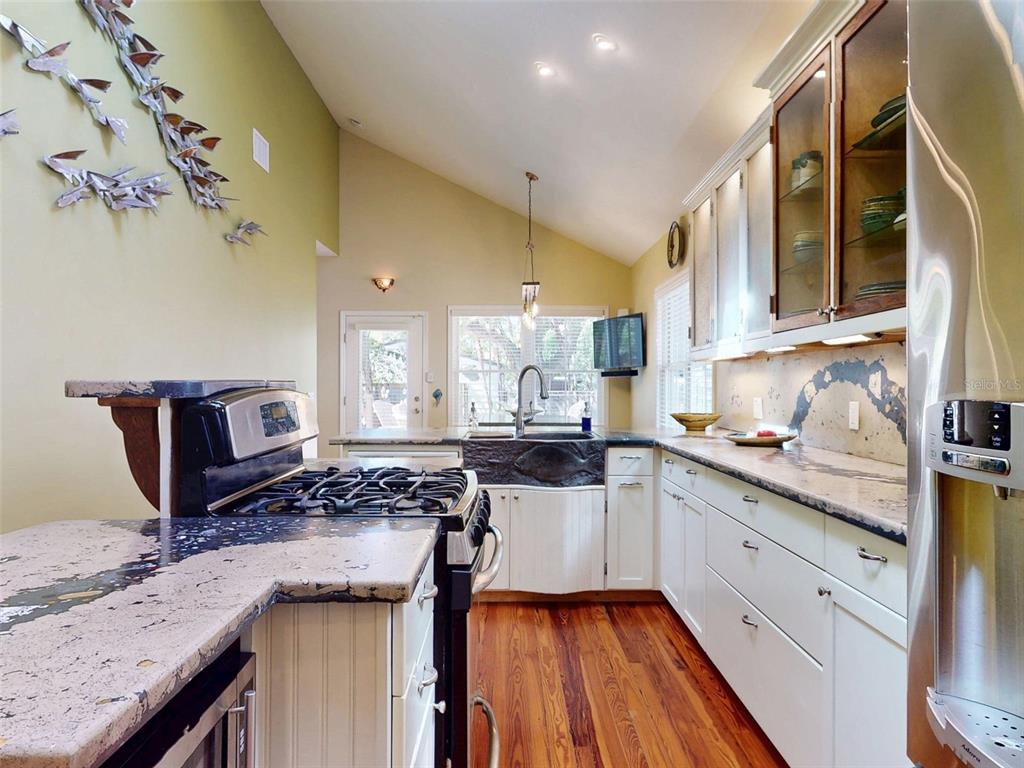 536 Faulkner Street New Smyrna Beach, FL 32168 - Photo 12 of 57 a kitchen with stainless steel appliances granite countertop a stove and a sink