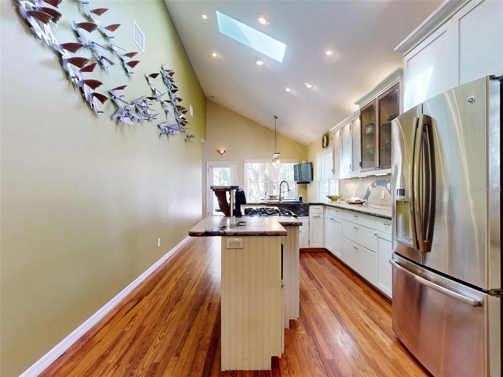 536 Faulkner Street New Smyrna Beach, FL 32168 - Photo 13 of 57 a kitchen with a refrigerator and a sink