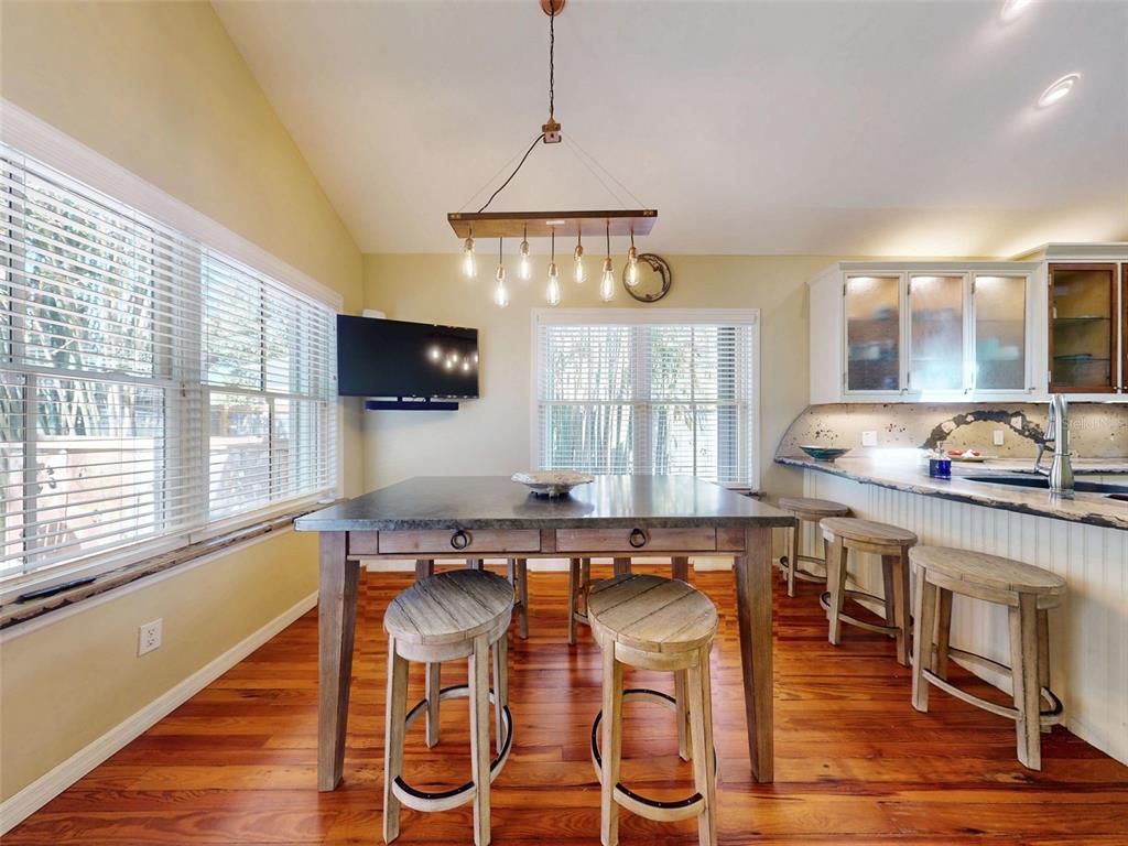536 Faulkner Street New Smyrna Beach, FL 32168 - Photo 14 of 57 a kitchen with stainless steel appliances granite countertop a sink and wooden floor