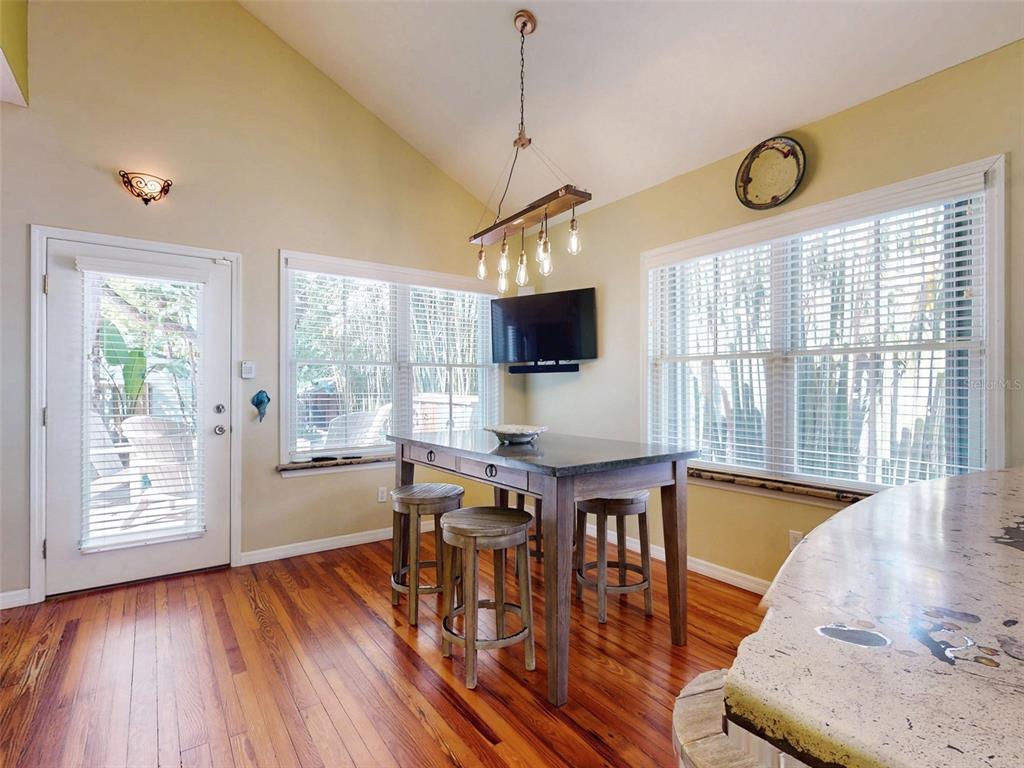 536 Faulkner Street New Smyrna Beach, FL 32168 - Photo 15 of 57 a view of a dining room with furniture window and wooden floor