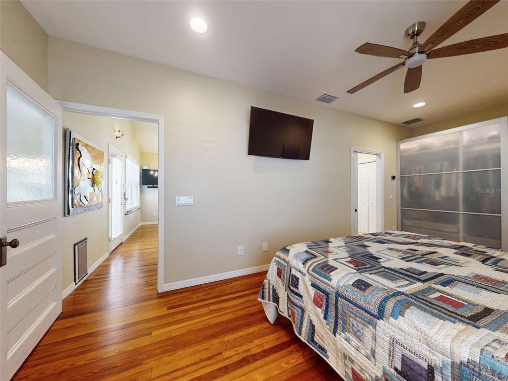 536 Faulkner Street New Smyrna Beach, FL 32168 - Photo 17 of 57 a bedroom with a bed and a flat screen tv