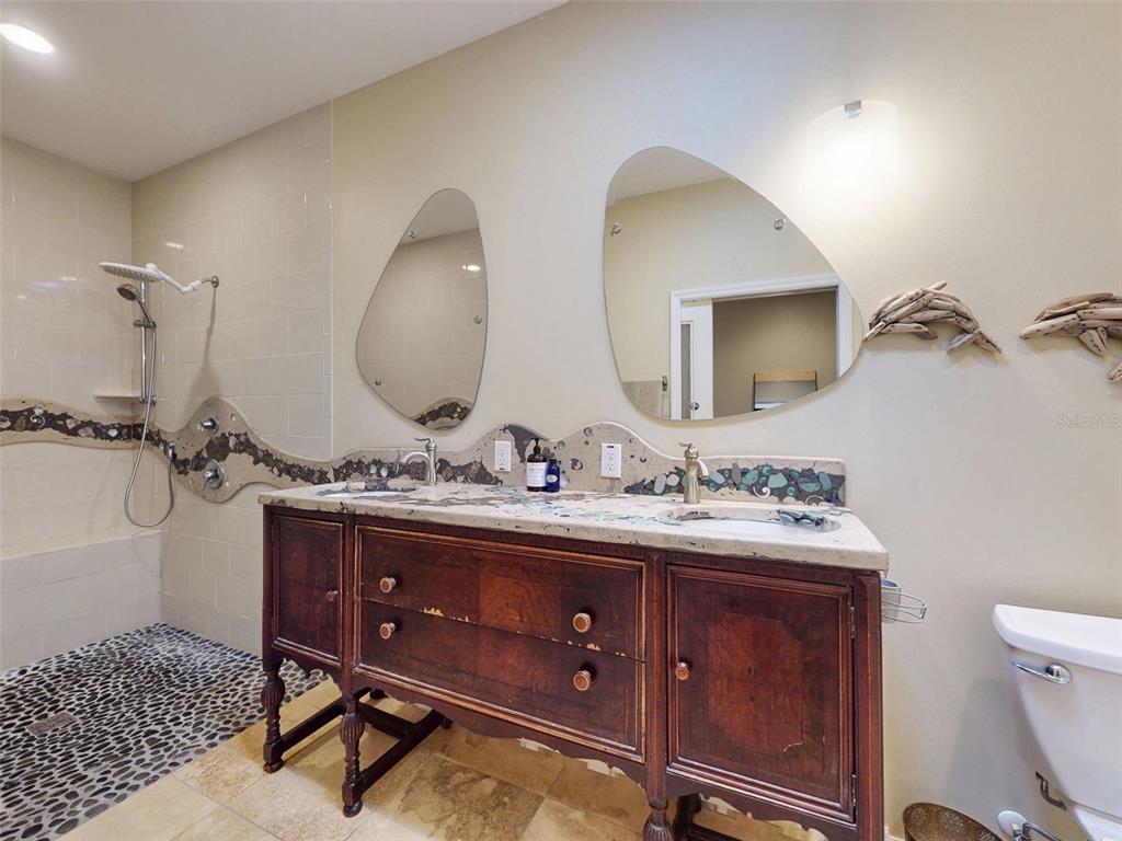 536 Faulkner Street New Smyrna Beach, FL 32168 - Photo 18 of 57 a bathroom with a toilet a sink and mirror