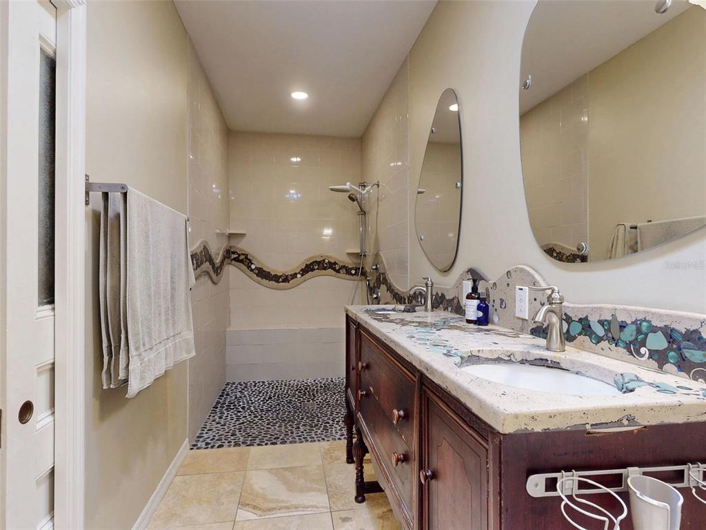 536 Faulkner Street New Smyrna Beach, FL 32168 - Photo 19 of 57 a bathroom with a granite countertop sink and a mirror