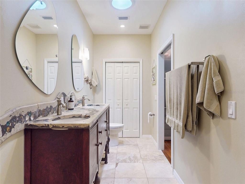 536 Faulkner Street New Smyrna Beach, FL 32168 - Photo 21 of 57 a en suite bathroom with a double vanity sink and a mirror