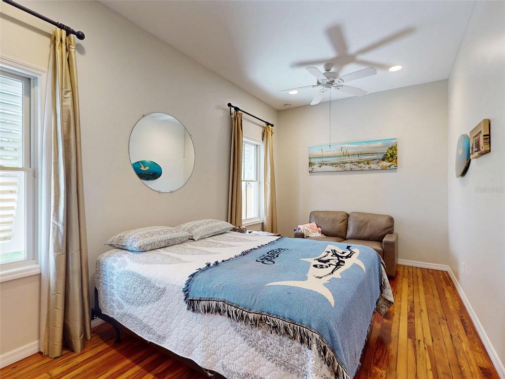 536 Faulkner Street New Smyrna Beach, FL 32168 - Photo 22 of 57 a bedroom with a bed and a chandelier