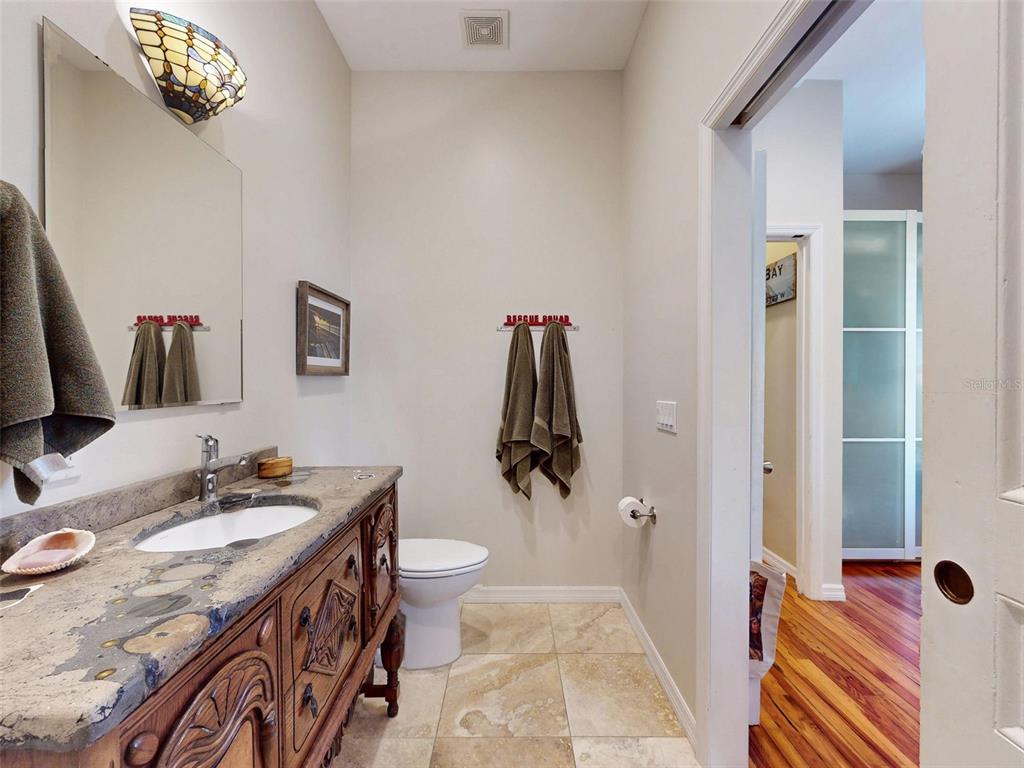 536 Faulkner Street New Smyrna Beach, FL 32168 - Photo 25 of 57 a bathroom with a sink and mirror with toilet