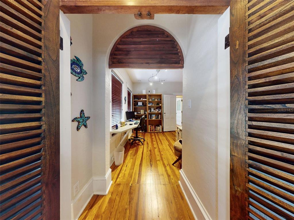 536 Faulkner Street New Smyrna Beach, FL 32168 - Photo 28 of 57 a view of a hallway with a chandelier