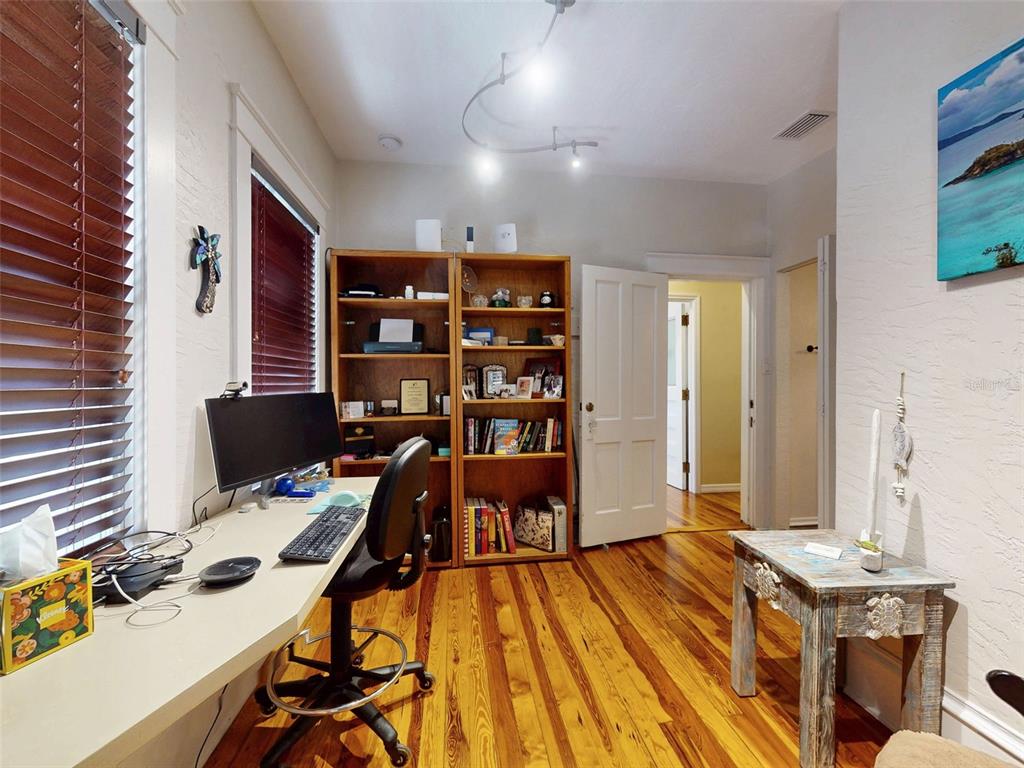 536 Faulkner Street New Smyrna Beach, FL 32168 - Photo 29 of 57 a view of a workspace with furniture and wooden floor