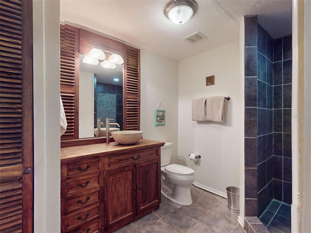 536 Faulkner Street New Smyrna Beach, FL 32168 - Photo 31 of 57 a bathroom with a double vanity sink a toilet and a mirror