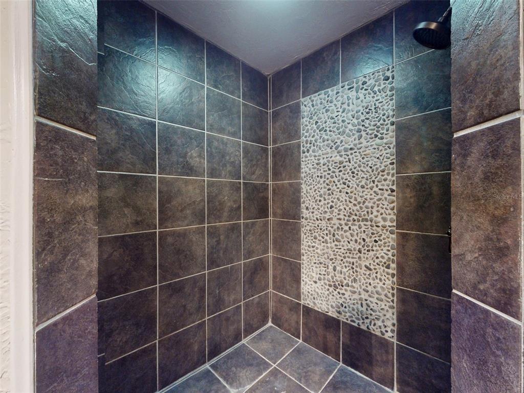 536 Faulkner Street New Smyrna Beach, FL 32168 - Photo 32 of 57 a bathroom with a shower