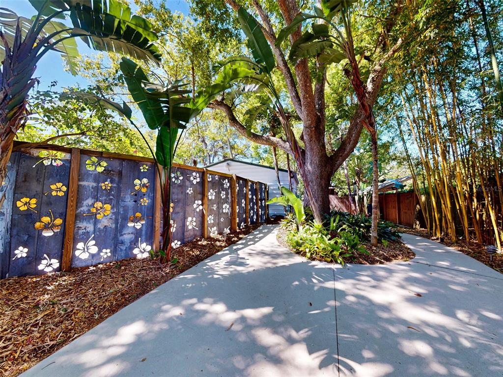 536 Faulkner Street New Smyrna Beach, FL 32168 - Photo 39 of 57 a pathway of a house with large trees