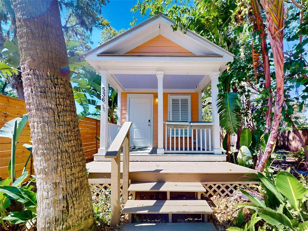 536 Faulkner Street New Smyrna Beach, FL 32168 - Photo 43 of 57 a front view of a house with a garden