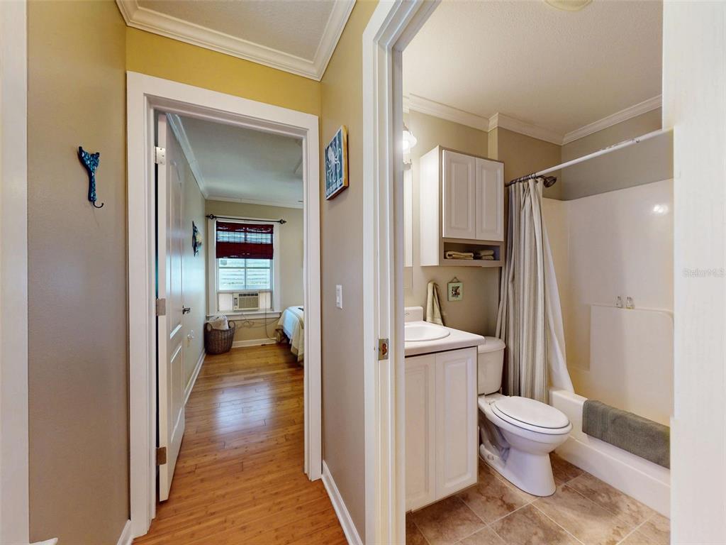 536 Faulkner Street New Smyrna Beach, FL 32168 - Photo 45 of 57 a bathroom with a glass door shower a toilet and a sink