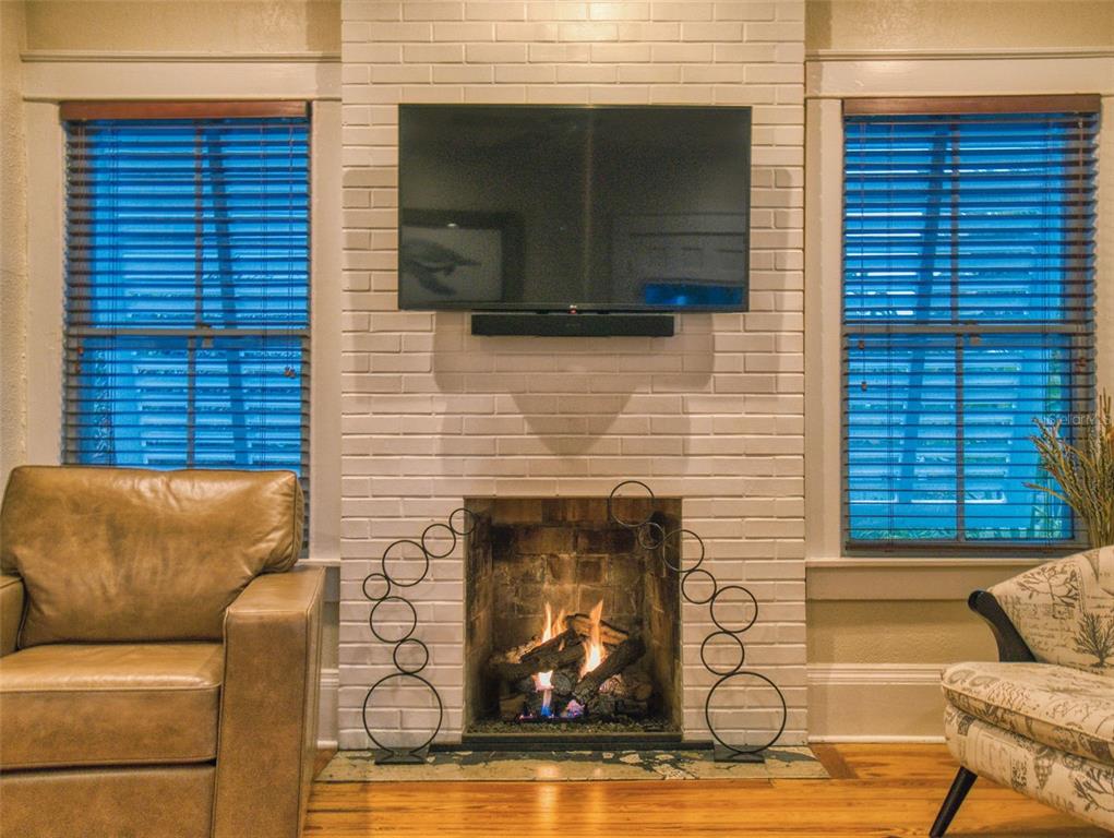 536 Faulkner Street New Smyrna Beach, FL 32168 - Photo 5 of 57 a view of a patio with couches chairs and a fireplace