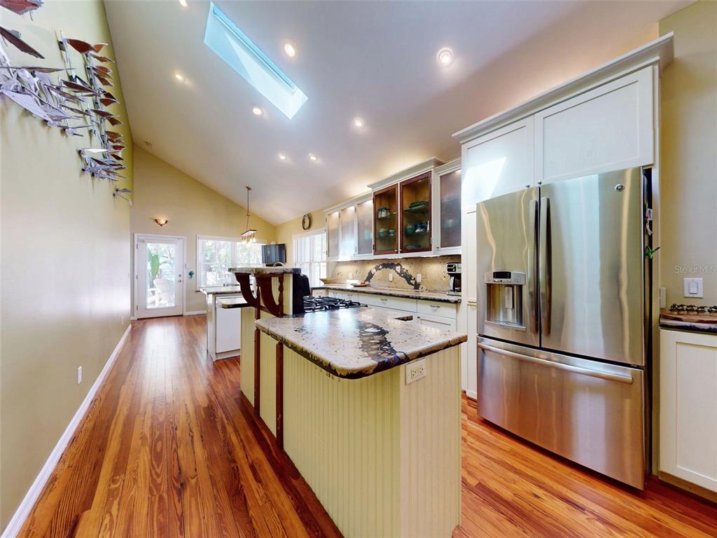 536 Faulkner Street New Smyrna Beach, FL 32168 - Photo 8 of 57 a kitchen with kitchen island a counter top space a sink a refrigerator and a stove