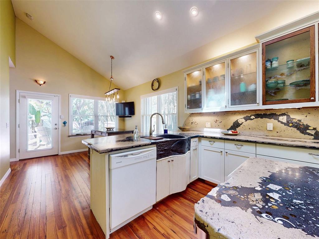 536 Faulkner Street New Smyrna Beach, FL 32168 - Photo 9 of 57 a kitchen with sink a stove and chairs