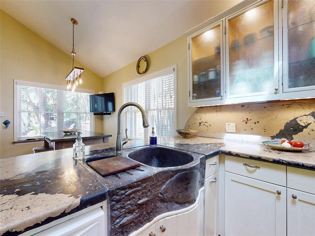 536 Faulkner Street New Smyrna Beach, FL 32168 - Photo 10 of 57 a kitchen with a sink a stove and cabinets