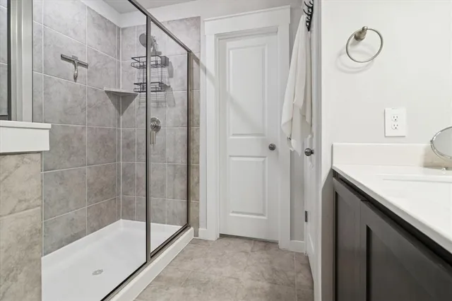 a bathroom with a granite countertop sink a toilet and shower