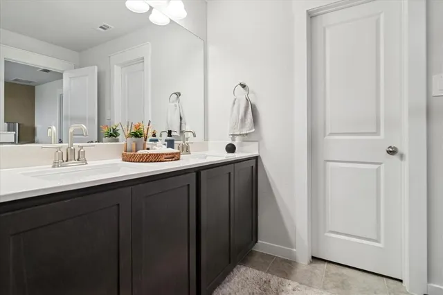 a bathroom with 2 sink and a mirror