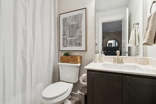 a bathroom with a toilet a sink and a mirror