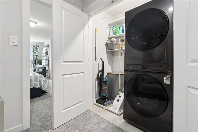 a utility room with wooden floor washer and dryer