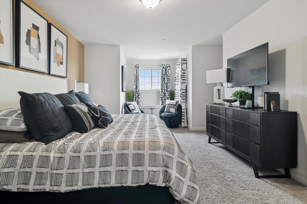 3047 Tenor Way Sachse, TX 75048 - Photo 9 of 17 a bedroom with a large bed and flat screen tv