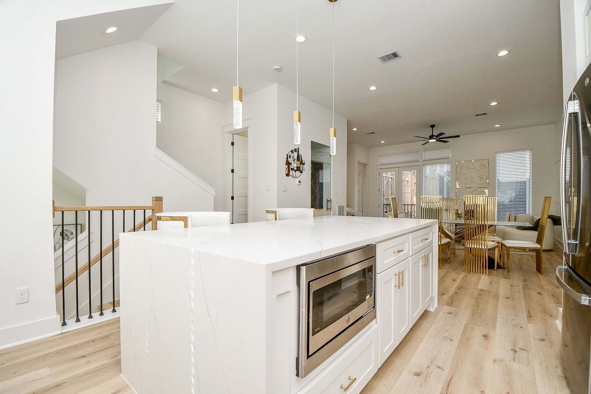 5611 Val Verde Street, Unit A Houston, TX 77057 - Photo 11 of 31 a large kitchen with stainless steel appliances kitchen island a large counter top a sink a stove and a refrigerator