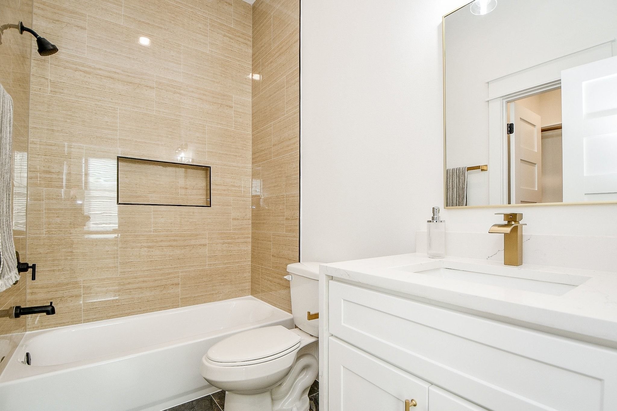 5611 Val Verde Street, Unit A Houston, TX 77057 - Photo 18 of 31 a bathroom with a granite countertop toilet a sink and a bathtub