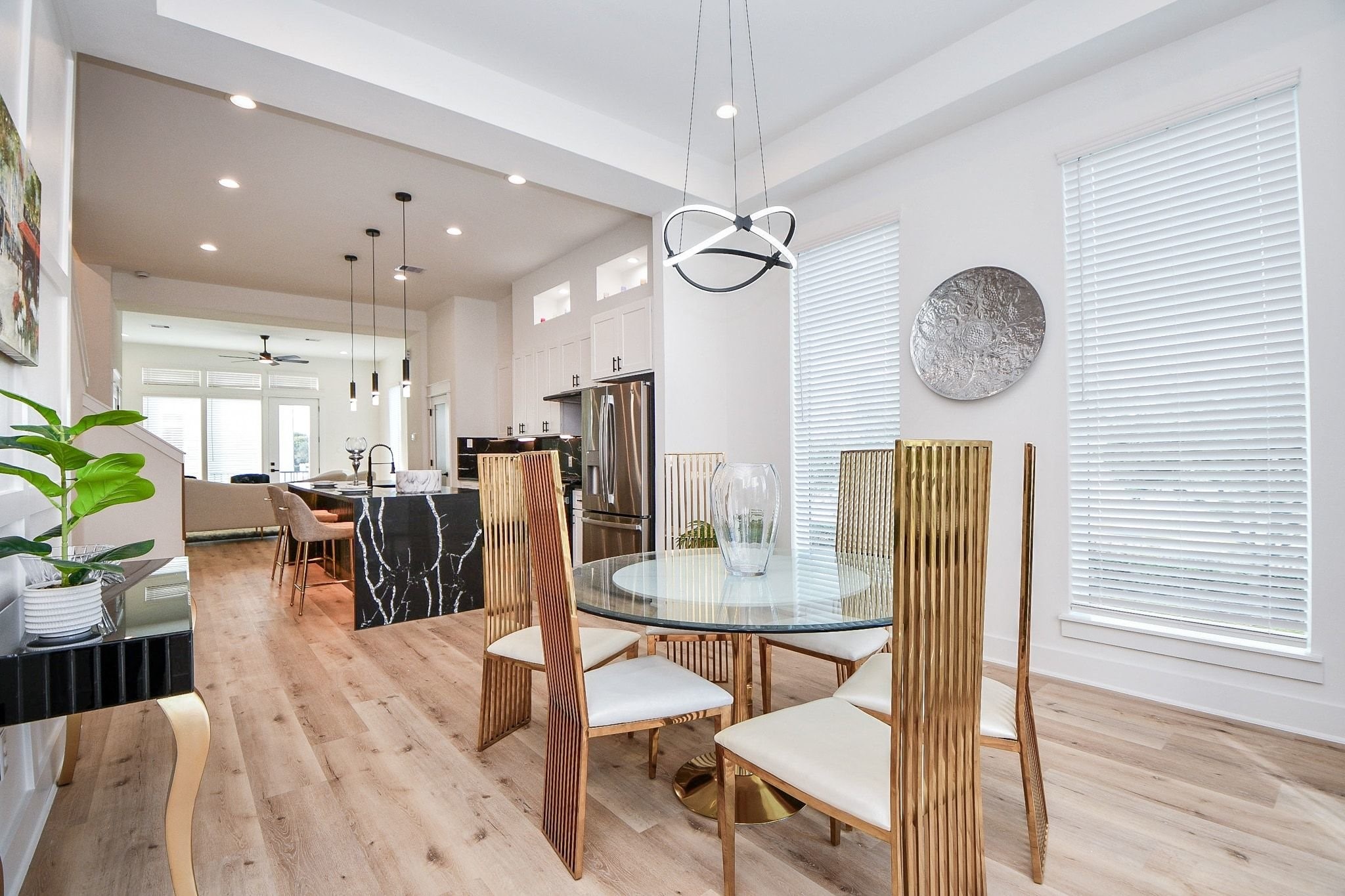 5611 Val Verde Street, Unit A Houston, TX 77057 - Photo 24 of 31 a view of a dining room and livingroom with furniture wooden floor a chandelier