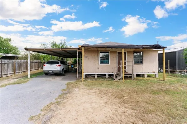 a view of a backyard with table and chairs