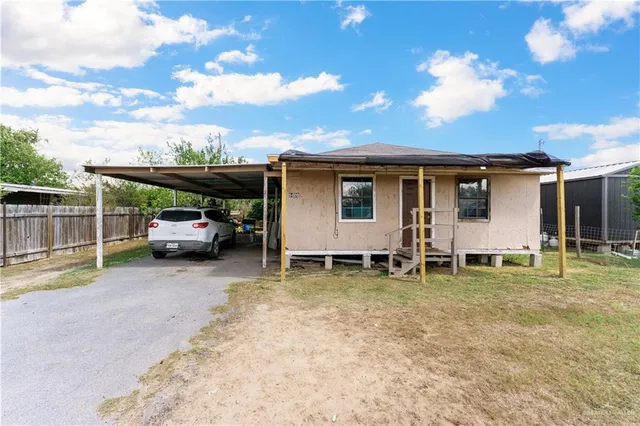 a view of a backyard with table and chairs