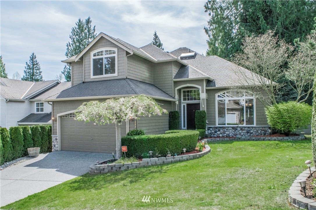 302 172nd Place Southeast Bothell, WA 98012 - Photo 1 of 20 a front view of a house with a yard and garage