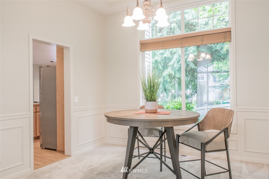 302 172nd Place Southeast Bothell, WA 98012 - Photo 12 of 20 a view of a dining room with furniture a chandelier and a window