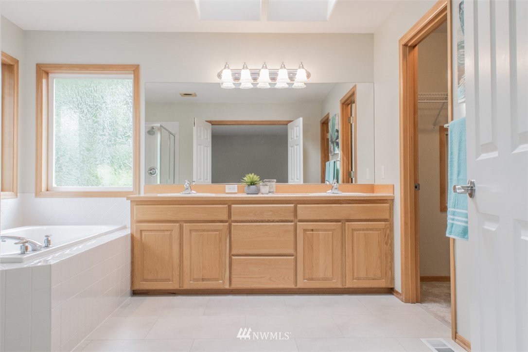 302 172nd Place Southeast Bothell, WA 98012 - Photo 16 of 20 a bathroom with a sink vanity and a mirror