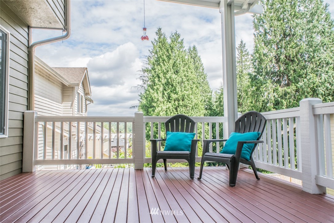 302 172nd Place Southeast Bothell, WA 98012 - Photo 18 of 20 a balcony with wooden floor table and chairs