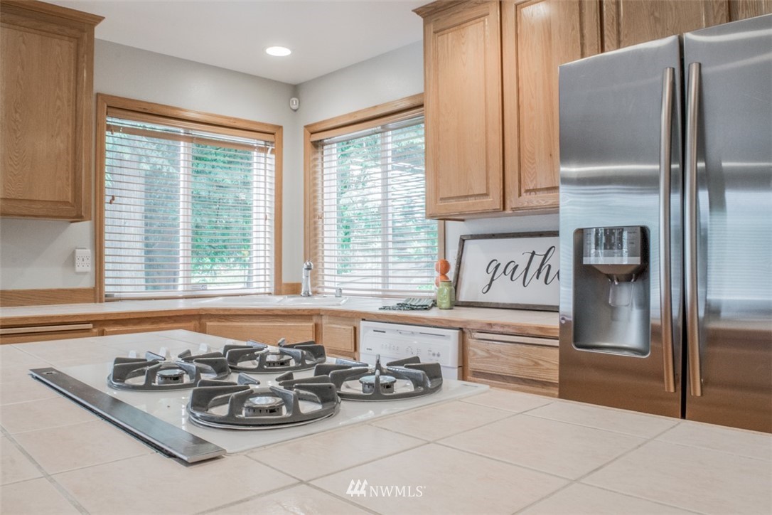 302 172nd Place Southeast Bothell, WA 98012 - Photo 3 of 20 a kitchen with stainless steel appliances granite countertop a refrigerator and a sink
