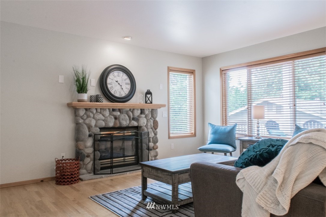 302 172nd Place Southeast Bothell, WA 98012 - Photo 4 of 20 a living room with furniture a window and a fireplace
