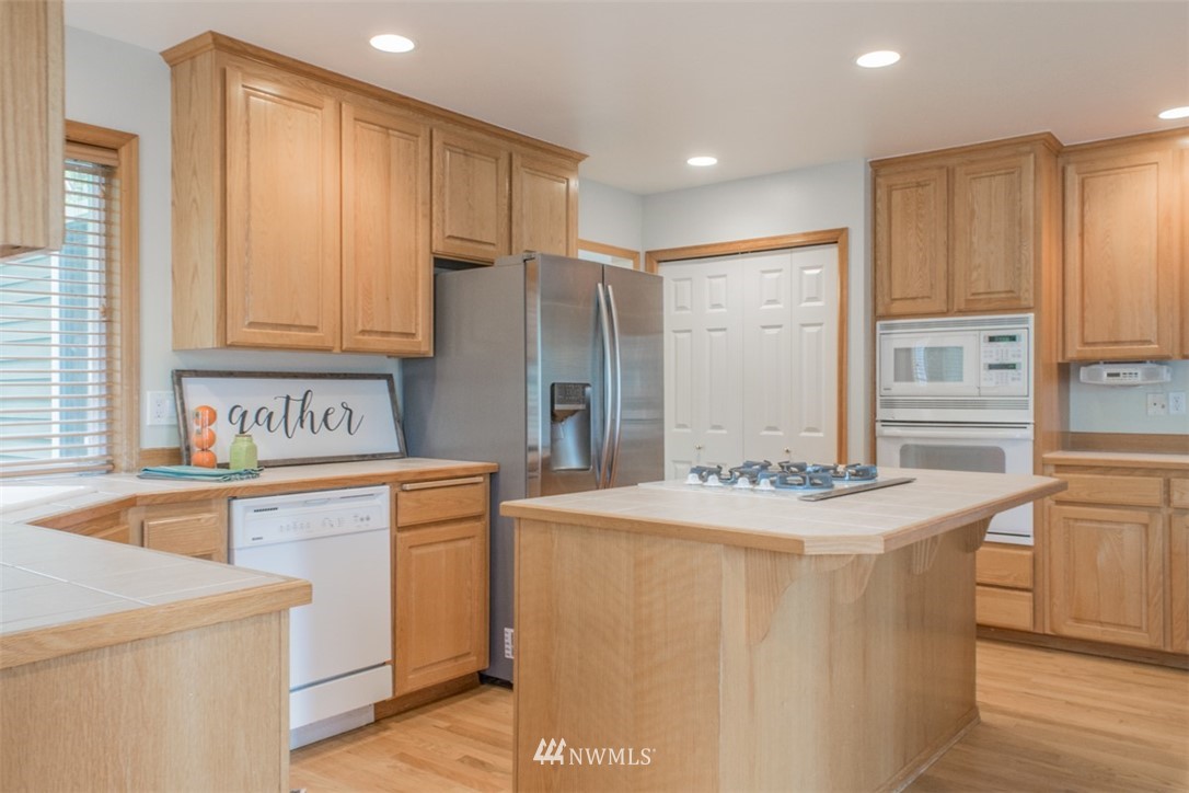 302 172nd Place Southeast Bothell, WA 98012 - Photo 5 of 20 a kitchen with stainless steel appliances granite countertop a sink stove and refrigerator
