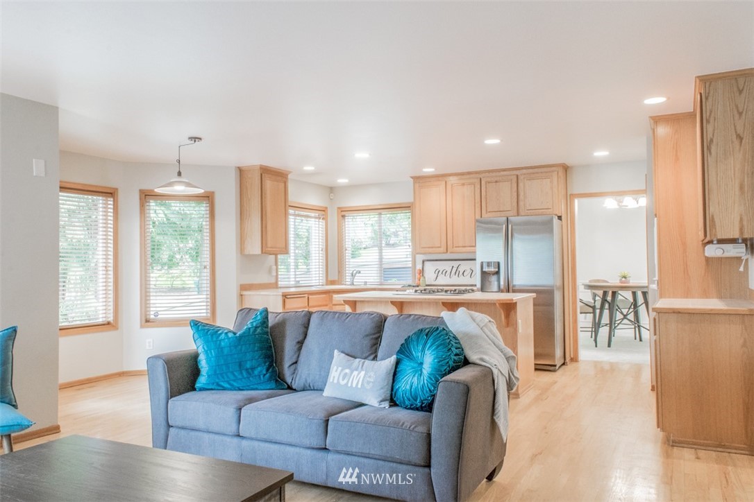 302 172nd Place Southeast Bothell, WA 98012 - Photo 7 of 20 a view of kitchen with kitchen island stainless steel appliances wooden floor and living room view