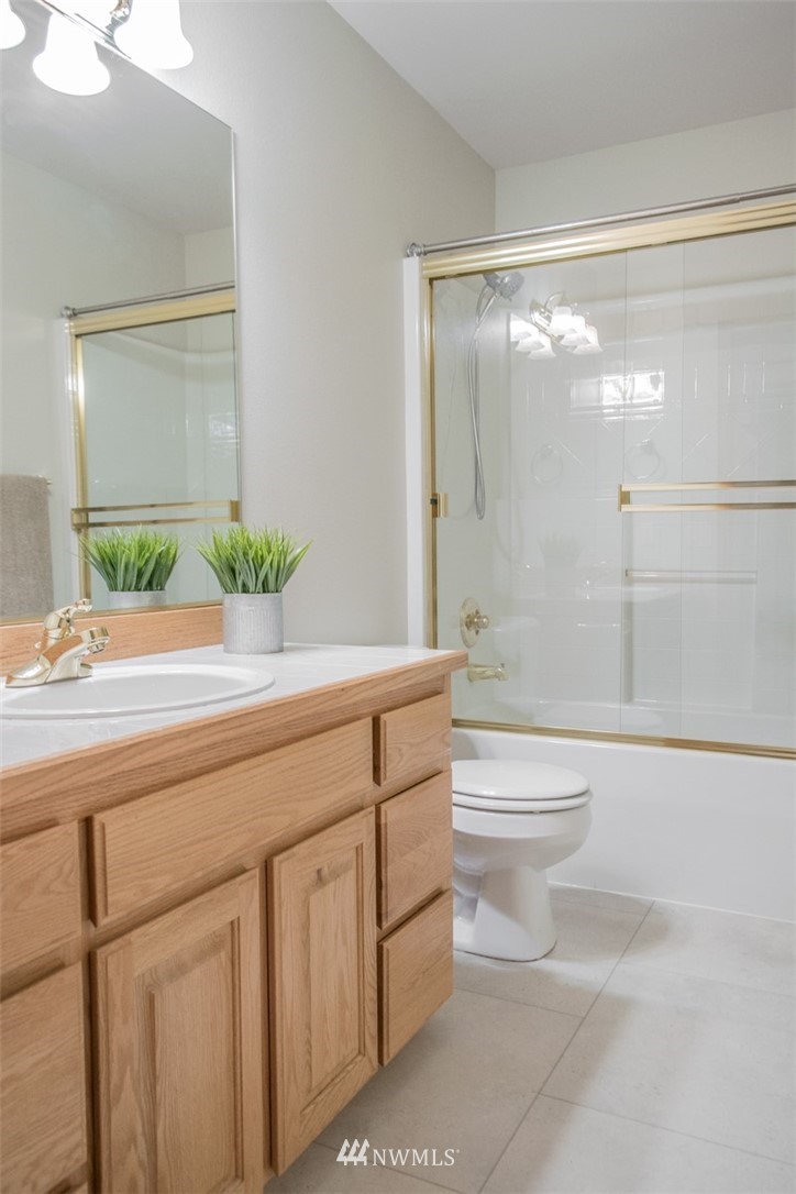 302 172nd Place Southeast Bothell, WA 98012 - Photo 10 of 20 a bathroom with a granite countertop sink a toilet and shower