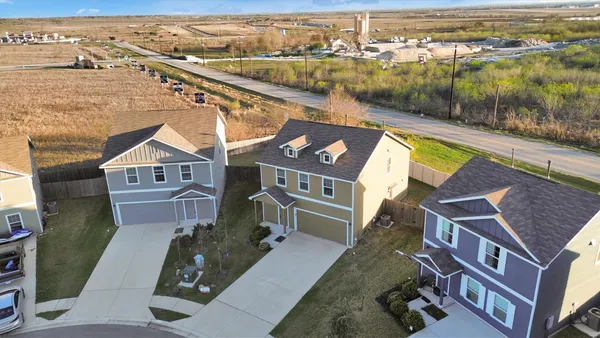 an aerial view of residential houses with outdoor space