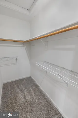 a view of a closet with wooden floor