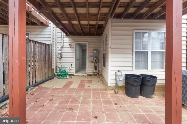 a view of a porch with a door and wooden floor