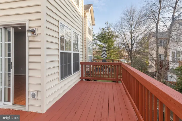a view of balcony with wooden floor and fence