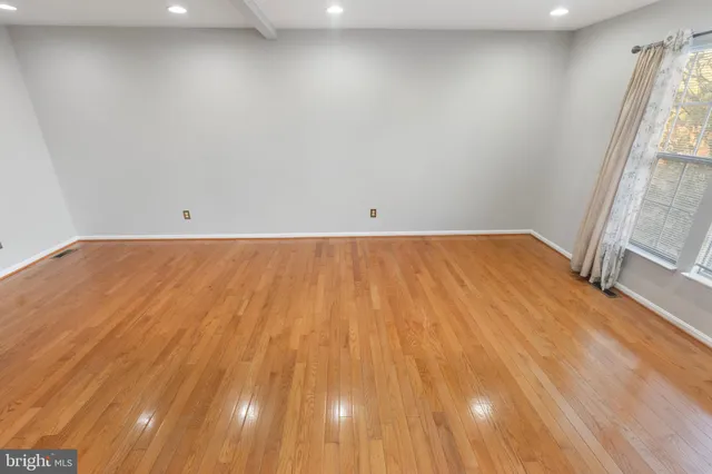 a view of a room with wooden floor and staircase