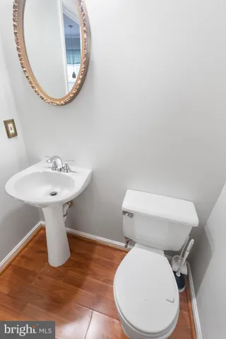 a bathroom with a sink toilet and a mirror