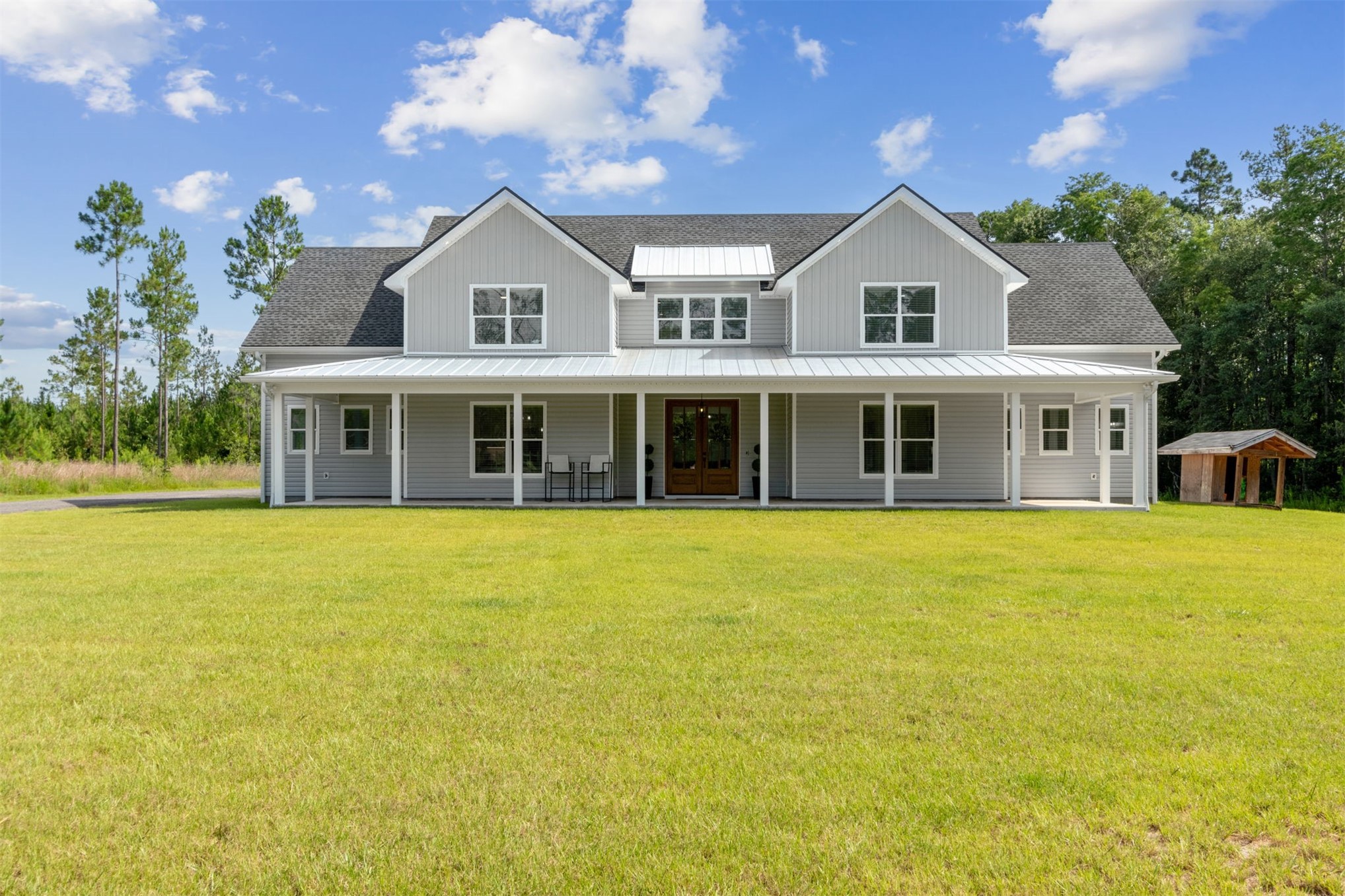 a front view of a house with a garden