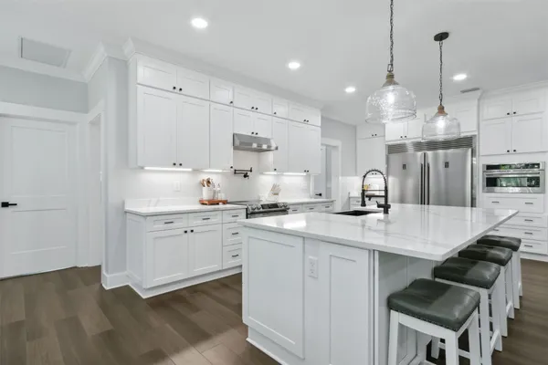 a kitchen with refrigerator and cabinets