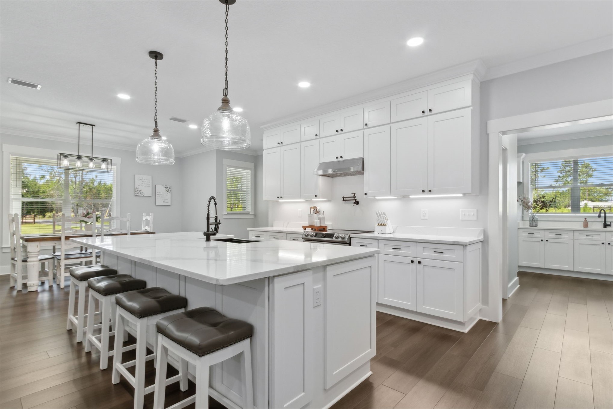 15550 County Road 108 Hilliard, FL 32046 - Photo 20 of 64 a kitchen with counter space dining table and wooden floor