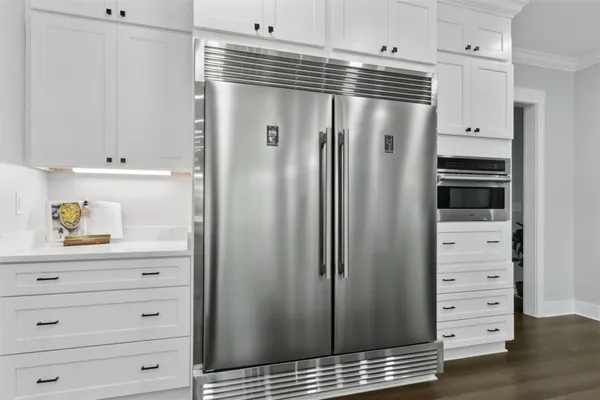 a kitchen with granite countertop white cabinets and a sink